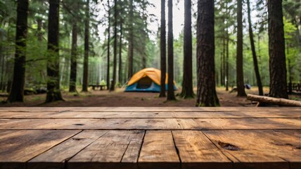 Wall Mural - A empty wooden table in the foreground with a tent and trees in the blurred background, suggesting an outdoor camping scene in a forest