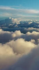 Wall Mural - flying above the clouds. aerial view of clouds at sunrise. traveling by air perfect background. vert