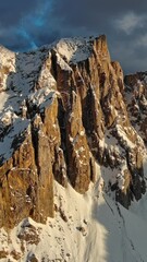 Wall Mural - aerial view of amazing rocky mountains in snow at sunset, dolomites, italy. vertical video