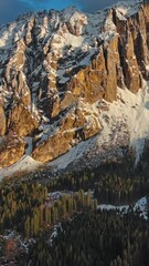 Wall Mural - aerial view of amazing rocky mountains in snow at sunset, dolomites, italy. vertical video