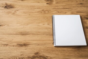 Aufkleber - Blank spiral notebook placed on a wooden desk for minimalistic workspace background