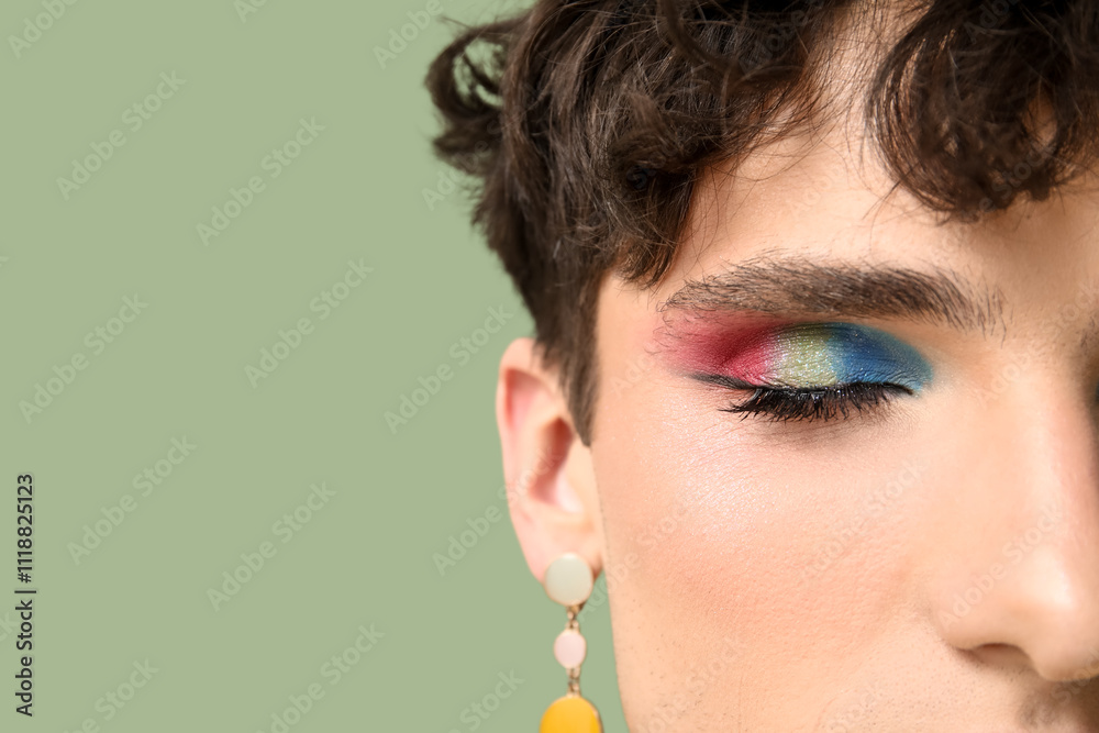 Young transgender woman on green background, closeup