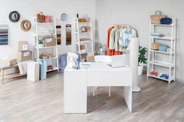 Sticker - Interior of online store warehouse with seller's workplace, clothes and accessories