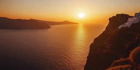 Wall Mural - A breathtaking view from a cliff overlooking the ocean, with the sun setting just above the horizon, casting golden hues across the water and illuminating the cliffside. 