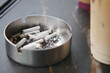 © Towfiqu Barbhuiya  - An ashtray containing cigarettes situated next to a refreshing beverage