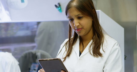 Poster - Beautiful scientist using digital tablet in laboratory