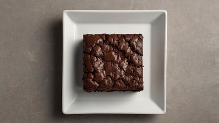 Chocolate brownie on paper on light grey base top view flat lay looking down