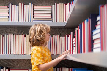 Fototapete - School boy. Pupil with pile of books. Children enjoying book story in school library. Kids imagination, interest to literature. Kids clever. Child study read book in class.