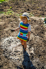 Poster - Child playing in mud. Selective focus.