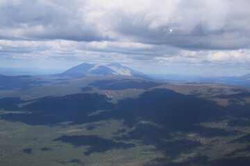 Wall Mural - A mountain range is visible in the distance with a blue sky above