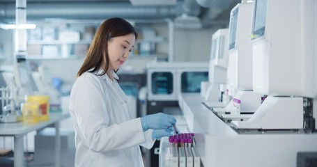 Leinwandbilder - Portrait of an Asian Female Scientist in White Lab Coat Handling Multiple Test Tubes in a Modern Laboratory. Researcher Conducts Precise Experiments with the Help of Biomedical Research Techniques