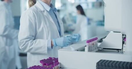 Leinwandbilder - Skilled Laboratory Technician Operating Advanced Diagnostic Equipment, Processing Blood Samples. Close Up on Anonymous Female Scientist Working in a Sterile Environment in Modern Healthcare Facility