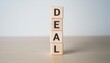 © TransPicHub - Wooden blocks spelling DEAL symbolize business negotiations.