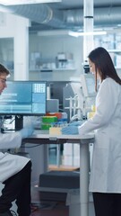 Aufkleber - Vertical Screen: Male Scientist and Asian Female Researches Discussing Experiment Observations. Female Coworker Preparing Samples for Chemical Analysis on a Polymerase Chain Reaction Machine