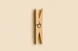 © saleem - A wooden clothespin on a plain background showcasing its simplicity and functionality
