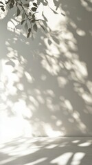 Poster - Natural light creates beautiful leaf shadows on a soft white wall indoors during daytime hours