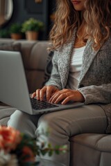 Poster - A person sitting on a couch with a laptop, possibly working or browsing