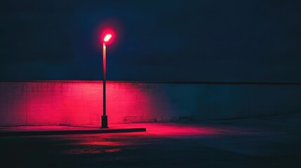 Poster - Neon illuminated lamp post casting vibrant pink light in a dark urban setting at night