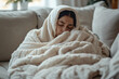 © digitalpochi - Unwell person seeking comfort under warm blanket while recovering from cold symptoms in home