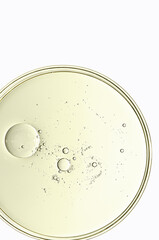 Wall Mural - The texture of a cosmetic serum or body gel in a Petri dish.