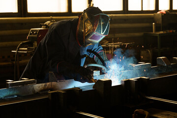 Poster - Craftsmanship shines through welding sparks in a vibrant workshop
