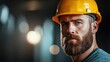© svastix - A serious-looking construction worker with a beard and yellow helmet is captured in a dimly-lit industrial setting, embodying dedication, focus, and modern industriousness.