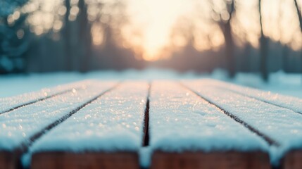 Fototapete - Snow covered wooden table in winter park at sunset