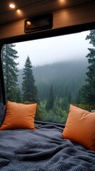 Aufkleber - Soft orange pillows rest on a cozy bed inside a cabin. Through large windows, a misty forest creates a serene atmosphere on a quiet morning
