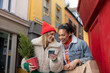 © ReeldealHD images - Young female friends Christmas shopping and looking at a smartphone