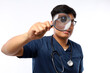 © ArvStd - Nurse holding a magnifying glass on a white background