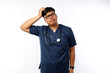 © ArvStd - Hispanic man feeling puzzled and confused, scratching head. nurse concept