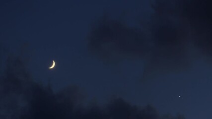 crescent moon and planet venus in astronomical conjunction time lapse in blue night sky