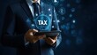 © Thanaporn - A realistic businessman in a suit holding a tablet with the word 'TAX' and icons representing growth and finance, a concept for online business.