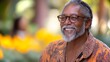 © Emiliia - A cheerful older man smiles warmly in a garden filled with vibrant flowers during a sunny day