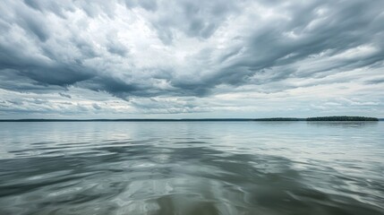 Aufkleber - Gentle waves glide across a smooth ocean surface, mirroring an expansive sky filled with soft gray clouds. The atmosphere exudes calmness, inviting reflection and peace