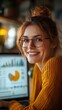 © Maestro - Woman smiling while working on business data analysis at desk