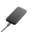 © Png - Video - Photo - Mobile phone charging on a black background, modern smartphone, technology in daily life.