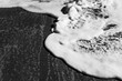© Andrew Kornylak - Black and white study of foamy waves overlapping on a beach on Hutchinson Island, Florida