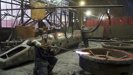 Wall Mural - An Industrial Workshop Featuring Workers Operating in a Heavy Machinery Environment. Stock Clip