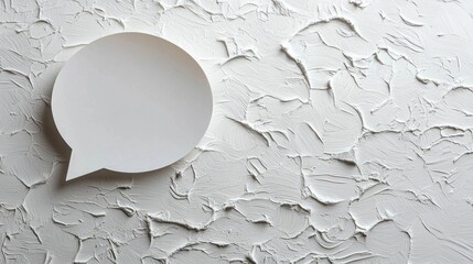 Poster - On a textured white background, a simple paper speech bubble captures attention, inviting thoughts and ideas. This artistic detail emphasizes communication in a modern setting