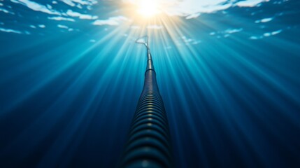 Leinwandbilder - A solitary fiber optic cable glows softly as it winds along the ocean floor, surrounded by deep blue water and subtle beams of light filtering from above