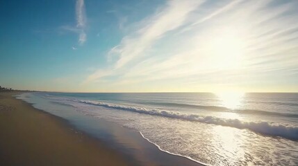 Poster - Tranquil ocean waves lap against the shore during sunset, with a clear sky and wispy clouds enhancing the peaceful atmosphere of this coastal location
