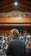 © Martn - Back view of mature professor giving lecture to large group of college students in the classroom.