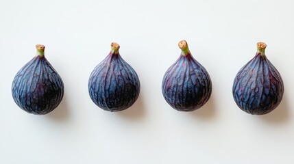 Aufkleber - Group of four whole fresh figs with deep purple skin arranged on a bright white background for a clean culinary presentation