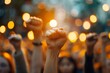 © Dhoku  Studio - A Close Up of a Raised Fist in a Crowd of People During a Protest