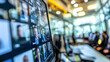 © Aditya - Close-up of a computer screen displaying a video conference with multiple participants. The blurry background suggests a modern office environment.
