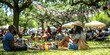 © Chanrothana Pech - A festive scene with people enjoying a Juneteenth holiday picnic in a park, decorated with flags and historic photos on display.