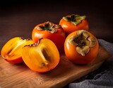 Persimmon tree fruits on wooden cutting board . Ripe orange Diospyros kaki fruits. Generated image 