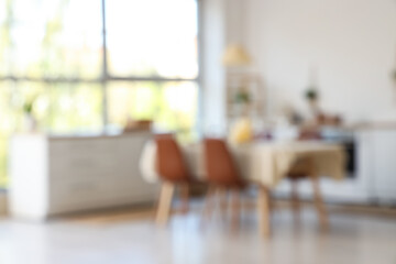 Wall Mural - Served dining table with candles in kitchen. Blurred view