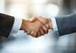 © ANUAR - Close-up of Two Businessmen Shaking Hands in a Modern Office Environment with Soft Focus Background, Symbolizing Partnership and Professional Agreement